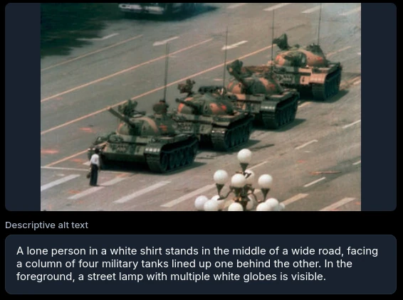 A lone person in a white shirt stands in the middle of a wide road, facing a column of four military tanks lined up one behind the other. In the foreground, a street lamp with multiple white globes is visible.